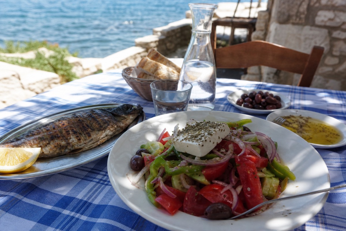 A taverna meal at a Greek island during Greece family vacation packages, an easy evening for kids