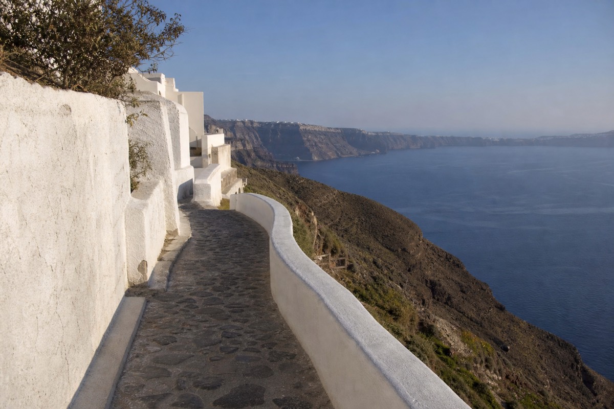 The Santorini caldera and the sunset at Oia along a cliff path on a Greece island hopping package